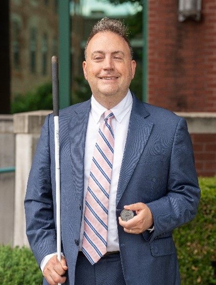 Mark Riccobono holds NFB membership coin